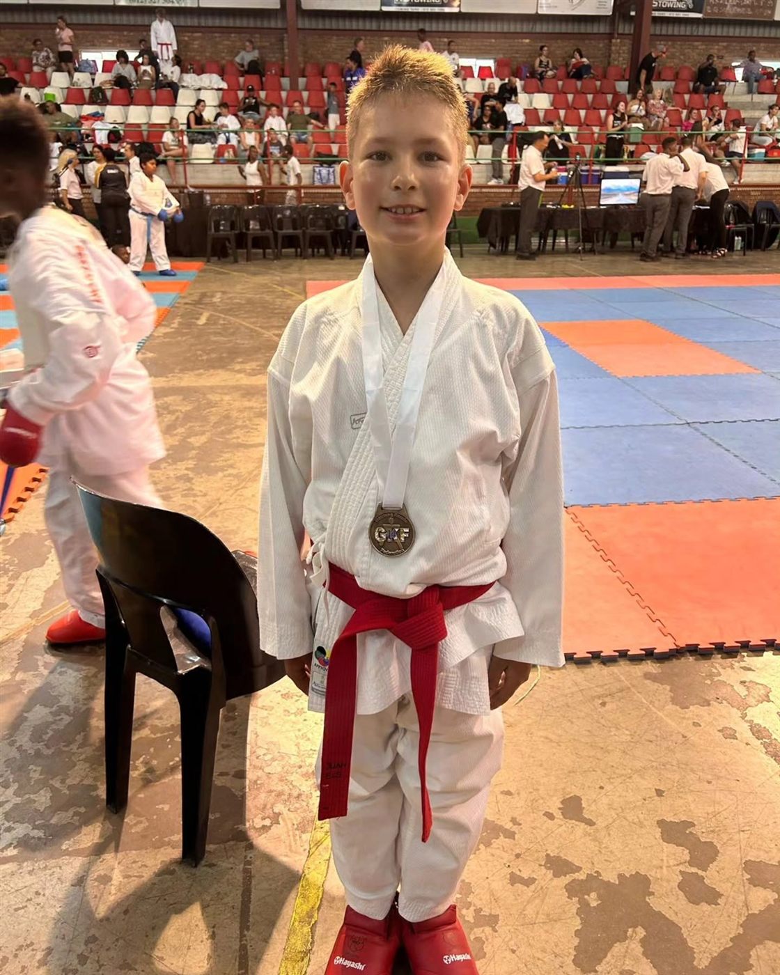 Young KarateZone athlete with a medal