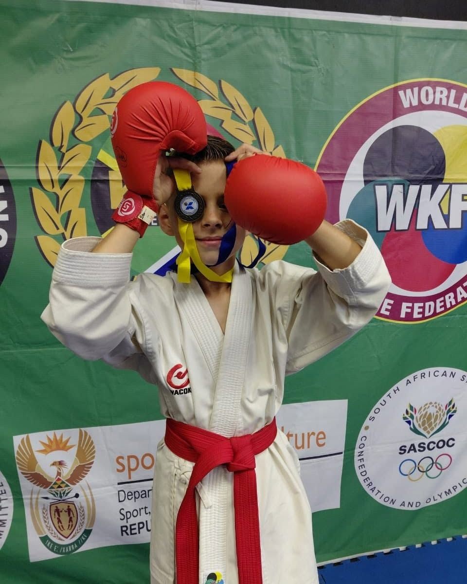 KarateZone athlete with a medal and red gloves